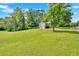 Expansive backyard with a sprawling lawn and mature trees offer privacy and space at 6918 Heritage Pl, Acworth, GA 30102