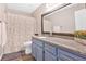 Bathroom features stylish vanity, granite countertop, updated fixtures, and decorative shower curtain at 6918 Heritage Pl, Acworth, GA 30102