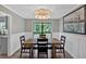 Bright dining room featuring views to the backyard, wood table and contemporary light fixture at 6918 Heritage Pl, Acworth, GA 30102