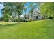 Charming home boasts a beautifully maintained lawn and mature trees at 6918 Heritage Pl, Acworth, GA 30102