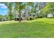 Charming home features lush green lawn, mature trees, and a welcoming front entrance at 6918 Heritage Pl, Acworth, GA 30102