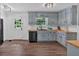 Well-lit kitchen with light blue cabinets, wood countertops, and modern appliances at 6918 Heritage Pl, Acworth, GA 30102