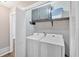 Convenient laundry room with modern washer and dryer, ample storage cabinets, and shelving at 6918 Heritage Pl, Acworth, GA 30102