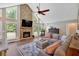 Cozy living room with stone fireplace, large windows, and a stylish sectional sofa at 6918 Heritage Pl, Acworth, GA 30102