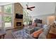 Comfortable living room featuring stone fireplace, vaulted ceilings, plush furniture, and streaming sunlight at 6918 Heritage Pl, Acworth, GA 30102