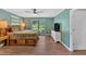Spacious main bedroom with a large bed, hardwood floors, ensuite bathroom and a large TV at 6918 Heritage Pl, Acworth, GA 30102