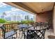 Spacious balcony with wrought-iron furniture and views of the cityscape beyond at 77 Peachtree Ne Pl # 101, Atlanta, GA 30309