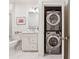 Bathroom with white vanity and marble flooring, plus a conveniently located stacked washer and dryer at 77 Peachtree Ne Pl # 101, Atlanta, GA 30309