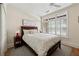 Comfortable bedroom featuring wood floors, ceiling fan and ample light from the window at 77 Peachtree Ne Pl # 101, Atlanta, GA 30309