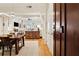 Open-concept dining room with hardwood floors, a wooden table, and access to the living room at 77 Peachtree Ne Pl # 101, Atlanta, GA 30309