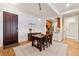 Dining room with hardwood floors, a wood table and chairs, white trim, and a view of the kitchen at 77 Peachtree Ne Pl # 101, Atlanta, GA 30309