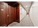 Hallway with unit 101 featuring hardwood door with gold hardware and carpeted floors at 77 Peachtree Ne Pl # 101, Atlanta, GA 30309