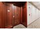 Hallway with unit 101 featuring hardwood door with gold hardware and carpeted floors at 77 Peachtree Ne Pl # 101, Atlanta, GA 30309