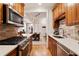 Open concept kitchen featuring stainless steel appliances and wood cabinetry at 77 Peachtree Ne Pl # 101, Atlanta, GA 30309