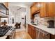 Open concept kitchen boasting stainless steel appliances and wood cabinetry at 77 Peachtree Ne Pl # 101, Atlanta, GA 30309