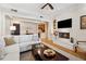 Open concept living room with hardwood floors, a fireplace, and a view into the kitchen at 77 Peachtree Ne Pl # 101, Atlanta, GA 30309