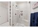 Elegant marble walk-in shower with glass door and built-in shelving at 77 Peachtree Ne Pl # 101, Atlanta, GA 30309