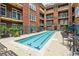 Outdoor pool surrounded by seating at a beautiful condominium building, perfect for relaxation at 77 Peachtree Ne Pl # 101, Atlanta, GA 30309