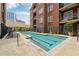Outdoor pool at a condominium community, with seating and landscaped areas at 77 Peachtree Ne Pl # 101, Atlanta, GA 30309