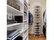 Organized walk-in closet with shelving for shoes, clothes, and storage baskets at 77 Peachtree Ne Pl # 101, Atlanta, GA 30309