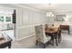 Traditional dining room featuring decorative trim, a chandelier, and access to the kitchen at 100 Spring Ridge Ct, Roswell, GA 30076