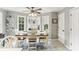 Traditional dining room features a wood table, bay window, and classic ceiling fan, perfect for Gathering meals at 100 Spring Ridge Ct, Roswell, GA 30076