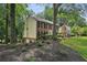 Charming two-story home with brick accents, mature trees, and a well-manicured lawn, offering curb appeal at 100 Spring Ridge Ct, Roswell, GA 30076