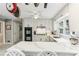 Well-lit modern kitchen with white countertops, stainless steel appliances and breakfast bar at 100 Spring Ridge Ct, Roswell, GA 30076