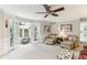 Bright living room with french doors to a sunroom and plush seating at 100 Spring Ridge Ct, Roswell, GA 30076
