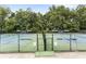 Well-maintained tennis courts surrounded by lush trees, providing an excellent space for sports and recreation at 100 Spring Ridge Ct, Roswell, GA 30076
