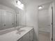 Clean bathroom with vanity and sink, large mirror, and a shower-tub combo at 110 Wyngate Way, Fayetteville, GA 30215