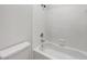 Bright bathroom features a clean white tiled tub and shower combo, with modern fixtures at 110 Wyngate Way, Fayetteville, GA 30215