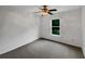 Unfurnished bedroom features neutral carpet, ceiling fan, and a window at 110 Wyngate Way, Fayetteville, GA 30215