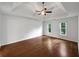 Bedroom boasts hardwood floors, two windows, tray ceilings and ceiling fan at 110 Wyngate Way, Fayetteville, GA 30215