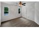 Empty bedroom with neutral carpet, ceiling fan, and two windows at 110 Wyngate Way, Fayetteville, GA 30215