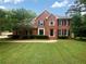 Charming two-story brick home with a well-manicured lawn and traditional architectural details at 110 Wyngate Way, Fayetteville, GA 30215