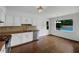 Bright eat-in kitchen with white cabinetry, stainless steel appliances, and a view of the backyard pool at 110 Wyngate Way, Fayetteville, GA 30215
