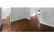Open living room with hardwood floors and views of a pool and other rooms at 110 Wyngate Way, Fayetteville, GA 30215