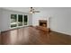 Bright living room with a brick fireplace, ceiling fan, and large windows overlooking the backyard pool at 110 Wyngate Way, Fayetteville, GA 30215