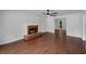 Living room features a brick fireplace, ceiling fan, and hardwood floors throughout at 110 Wyngate Way, Fayetteville, GA 30215