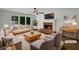 Staged living room featuring a cozy fireplace, large windows, and modern furnishings at 110 Wyngate Way, Fayetteville, GA 30215