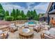 Gorgeous backyard with a luxurious pool, stone features, fire pit, and lounge seating at 120 Slate Dr, Buford, GA 30518