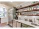 Charming bar area with sleek stainless appliances, open shelving and beverage center, perfect for entertaining at 120 Slate Dr, Buford, GA 30518