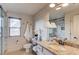 Bright bathroom with a glass-enclosed shower, granite countertop vanity, and shiplap wall accents at 120 Slate Dr, Buford, GA 30518