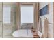 Bright bathroom featuring a freestanding tub, marble tile, and modern fixtures, creating a spa-like retreat at 120 Slate Dr, Buford, GA 30518