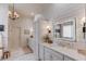 Bright bathroom with dual sinks, shiplap walls, and elegant chandelier at 120 Slate Dr, Buford, GA 30518
