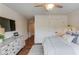 Bedroom featuring shiplap walls, hardwood floors, and a light gray dresser under a wall-mounted TV at 120 Slate Dr, Buford, GA 30518