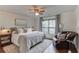 Inviting bedroom featuring plush bedding, a cozy armchair, and soft lighting at 120 Slate Dr, Buford, GA 30518
