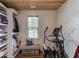 Well-organized closet space with built-in shelving, wood ceiling, and exercise equipment at 120 Slate Dr, Buford, GA 30518