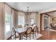 Formal dining area with custom curtains and backyard views at 120 Slate Dr, Buford, GA 30518